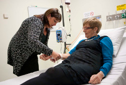 Checking on a patient during a transfusion